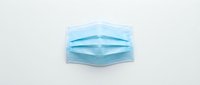 Disposable blue medical face mask isolated on white background, ready for healthcare, safety, and pandemic-related design projects.