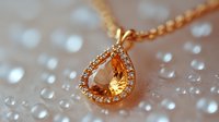 Elegant teardrop pendant necklace in rose gold with crystal gems and diamonds on blurred background with water droplets creating dreamy bokeh effect.
