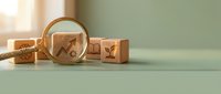 Magnifying glass focusing on wooden cube with growth arrow icon, surrounded by business and education blocks on green background.