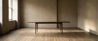 Minimalist wooden dining table in empty room with natural light from window, modern interior design concept for home decor and furniture styling.