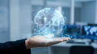 Global network connection and digital communication technology displayed as holographic globe above businessman's hand in modern office environment for business solutions.