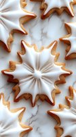 Festive gingerbread cookies with white icing arranged in decorative star and spiral shapes on marble surface for holiday baking and Christmas celebrations.