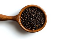 Whole black peppercorns in rustic wooden spoon on white background, aromatic spice macro photography for cooking and seasoning concepts.