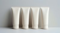 White cosmetic tubes standing in row on light background, blank mockup for cream, lotion or skincare product packaging design. Clean minimal style.