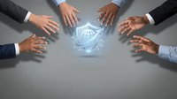 Business team hands protecting glowing cybersecurity shield icon representing data protection and digital security collaboration in corporate environment.