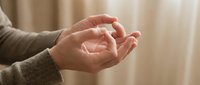 Caucasian adult hands in open gesture against neutral beige background, conveying trust, giving, or receiving concept for business and wellness applications.