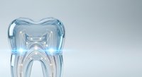 Translucent tooth-shaped glass sculpture with blue tint on white background, isolated dental model for healthcare design, dentistry education, and medical illustration projects.