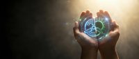 Hands holding a glowing wind turbine icon with light rays, symbolizing clean energy, renewable power, and sustainable technology innovation.