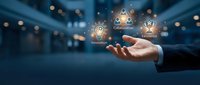 Businessman hand holding glowing icons representing innovation, collaboration, and leadership in modern corporate environment for business strategy and growth concepts.