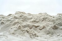 Fine white sand dunes creating natural abstract landscape with soft shadows and textures, minimal desert terrain formation against light background.