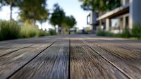 Rustic wooden deck boards in perspective view with shallow depth of field, blurred background of residential area and garden landscaping creates serene atmosphere.