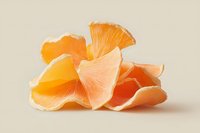 Fresh peeled grapefruit segments arranged in artistic composition showing juicy pulp and delicate membranes on neutral beige background. Macro food photography.