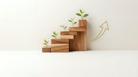 Wooden blocks arranged as ascending stairs with green plants sprouting from each level, symbolizing growth, progress and sustainable development.