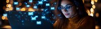Young Asian woman in glasses working on laptop at night with glowing message icons, digital communication concept. Email marketing and online messaging background.