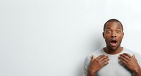 Man with shocked expression wearing light gray sleeveless shirt, isolated on white background, suitable for advertising, web design, and marketing materials.