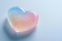 Translucent heart shape with soft pink and blue gradient colors on light background, creating romantic ethereal mood for valentines and love concepts.