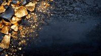 Gold leaf fragments and dust scattered on dark textured background with copy space, creating luxurious contrast for elegant design layouts.