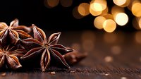 Star anise pods on dark wooden surface with golden bokeh lights in background, macro food photography highlighting aromatic spice texture and natural pattern.