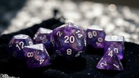 Purple polyhedral dice set with silver numbering on black velvet surface for tabletop gaming, role-playing games, and dungeon adventures.
