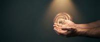 Male hands holding glowing brain with neural connections on dark background representing artificial intelligence, mental health, and cognitive science concepts.