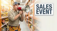 Male store employee with megaphone announcing sales event in grocery store aisle. Retail worker promoting special offers and discounts to customers.