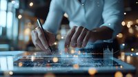 Businessman analyzing digital data on transparent tablet with glowing graphs and charts in modern office environment with bokeh lights.