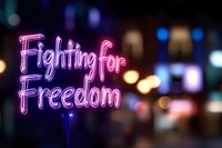 Pink neon sign reading Fighting for Freedom against blurred city lights background at night for protest and activism campaigns.