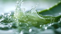 Dynamic water splash with crystal clear droplets creating crown-like formation against soft green background, captured in macro with shallow depth of field.