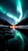 Aurora borealis dancing over frozen mountain landscape with glowing lights reflecting in calm winter lake water at night.
