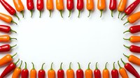Colorful hot chili peppers arranged in oval frame on white background creating spicy border for culinary design and cooking projects.
