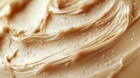 Creamy peanut butter spread with smooth swirls and rich texture, perfect for food photography, cooking blogs, and culinary marketing materials.