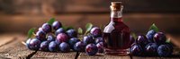 Fresh ripe plums and homemade plum liqueur in glass bottle on rustic wooden background, perfect for culinary, harvest or autumn seasonal designs.