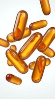 Golden amber capsules floating on white background for pharmaceutical and healthcare supplement design applications.
