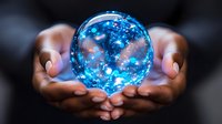 Glowing blue crystal ball with magical sparkles and light effects floating between cupped hands against dark background, creating mystical atmosphere.