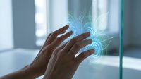 Hands interacting with holographic digital interface displaying glowing blue circuit patterns and futuristic technology elements in modern office environment.