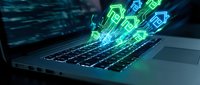 Digital currency symbols emerging from laptop keyboard with glowing neon effects representing cryptocurrency trading and blockchain technology concepts.