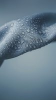 Water droplets cover a curved surface in close-up detail, showcasing hydrophobic properties and moisture beading. Use for environmental, industrial, or product protection concepts.