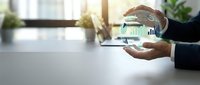 Business professional analyzing financial data and charts on digital tablet in modern office environment for strategic planning and growth analysis.