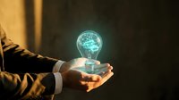 Businessman holding glowing light bulb with brain inside representing innovation, creativity, and bright ideas for business solutions and strategic thinking.