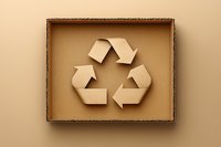 Recycling symbol made from kraft paper arrows in cardboard box on beige background. Eco-friendly packaging and sustainable waste management concept.