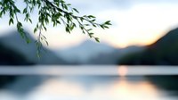 Tranquil mountain lake at sunset with willow branches hanging in foreground, creating serene nature composition with water reflection and soft pastel sky.
