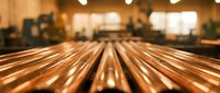 Wooden table surface with blurred restaurant interior background, warm lighting creates cozy dining atmosphere for food photography and culinary presentations.
