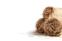 Natural coconut fiber coir bundle on white background, organic raw material used in gardening, crafts and eco-friendly products manufacturing.