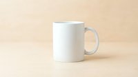 White ceramic coffee mug mockup on beige background for branding and design projects.