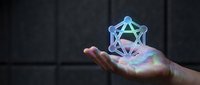 Holographic geometric wireframe symbol glowing in open palm against dark background, representing technology, innovation, and digital transformation for futuristic concepts.