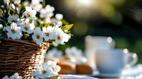 Fresh white spring blossoms in wicker basket on wooden table with morning sunlight, coffee cup and pastries creating cozy breakfast atmosphere.