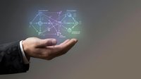 Businessman hand holding glowing digital network diagram with connected nodes and data flow visualization for technology, innovation, and business solutions.