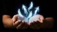 Glowing white human figures emerging from cupped hands against dark background representing spiritual guidance, leadership and human potential concepts.