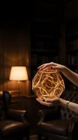 Woman holding glowing geometric orb with warm golden light in dark interior space with lamp, suitable for wellness and mindfulness concepts.