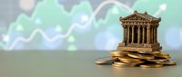 Classical bank building model on golden coins with rising financial charts background representing economic growth and investment success.